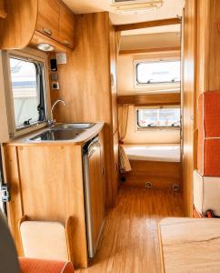 a kitchen in an rv with a sink at CamperTenerife in Callao Salvaje +2 photos