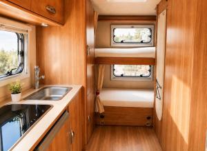an rv kitchen with a sink and a window at CamperTenerife in Callao Salvaje