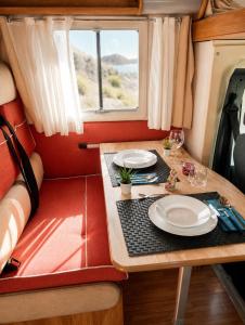 a dining table in a camper with two plates on it at CamperTenerife in Callao Salvaje