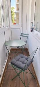 a table and chair in a room with a window at Deivido apartamentai Šiauliuose in Šiauliai