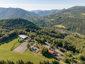 an aerial view of a farm with mountains in the background at Agriturismo La Nevera in Lanzo dʼIntelvi