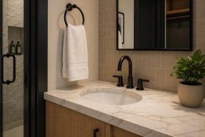 a bathroom with a sink and a mirror at Stonebridge Inn in Snowmass Village