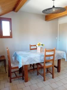 a dining room with a blue table and chairs at oiseau bleu in Dieppe +5 photos