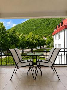 a patio with two chairs and a table on a balcony at Lux Apartman Casablanca in Plužine