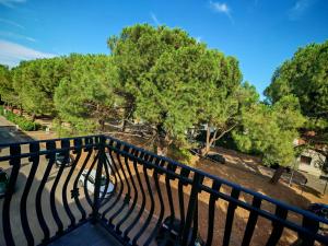 a balcony with a black railing and trees at Motel Villaggio in Imola