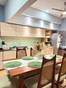 a kitchen with a wooden table with chairs and a dining room at Casa Alma de Mar in Brisas de Zicatela