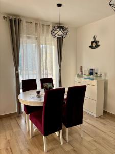 a dining room with a table and chairs and a kitchen at Lux Apartman Casablanca in Plužine