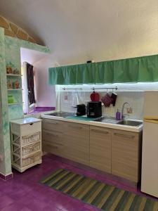 a kitchen with a sink and a counter top at Il tuo rifugio all' Argentario in Porto Santo Stefano