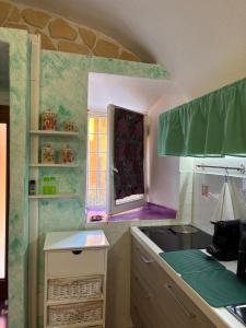 a kitchen with a sink and a window at Il tuo rifugio all' Argentario in Porto Santo Stefano