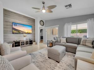 a living room with a couch and a ceiling fan at 153rd Surprise in Surprise
