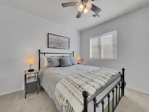 a bedroom with a bed and a ceiling fan at 153rd Surprise in Surprise +36 photos