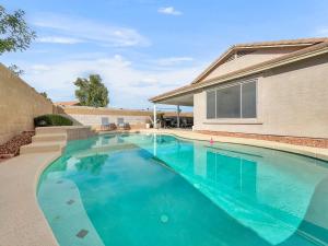 a swimming pool in front of a house at 153rd Surprise in Surprise