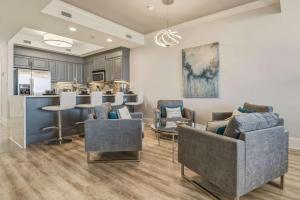 a kitchen and living room with chairs and a table at Luxury GulfFront Penthouse with Resort Amenities in Dauphin Island