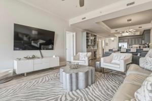 a living room with a couch and a table at Luxury GulfFront Penthouse with Resort Amenities in Dauphin Island