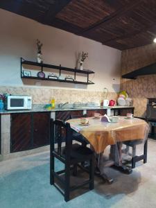 a kitchen with a wooden table in a kitchen at Hostel El Alamo in Maimará
