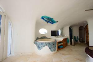 a bathroom with a fish on the wall at Shark Studio Retreat at Swan Villas - Gold Standard Certified in Maya Beach