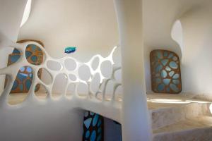 a room with a staircase with stained glass windows at Shark Studio Retreat at Swan Villas - Gold Standard Certified in Maya Beach
