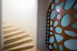 a set of stairs in a room with a mirror at Shark Studio Retreat at Swan Villas - Gold Standard Certified in Maya Beach +15 photos