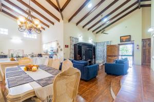 a dining room and living room with a table and chairs at Campo Verde House in San Ignacio
