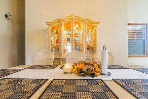 a dining room table with a candle and flowers on it at Campo Verde House in San Ignacio +20 photos