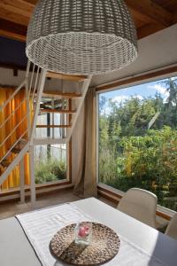 a room with a table and a large window at An Dina House in Dina Huapi