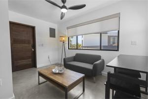 a living room with a couch and a table at Beyond the Blue Casita in Placencia