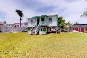 a house with a staircase in a yard at DV #2 at DV Cabanas -Gold Standard Certified in Caye Caulker