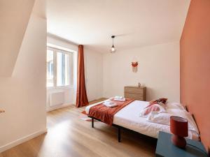 a bedroom with a bed and a window at 8B - Le Cosy in Saint-Rambert-dʼAlbon