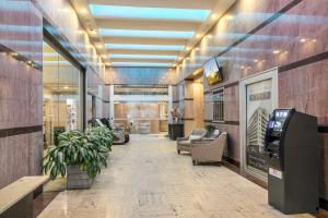 a lobby with a waiting area with chairs and a cash register at California Building in New Orleans