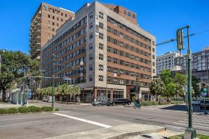 an intersection with a large building on a city street at California Building in New Orleans