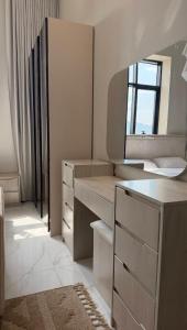 a bathroom with a sink and a mirror in it at شقق ميلا الباحة الفاخرة in Al Baha +9 photos