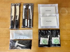 a group of bags with utensils on a table at HOTEL Progress inn 名護 MATABee in Nago