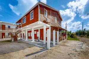 a large wooden house with white columns at Spartan Unit 11 in Caye Caulker