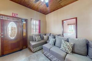a living room with a couch and a door at Spartan Unit 11 in Caye Caulker