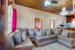 a living room with a couch and a ceiling fan at Spartan Unit 11 in Caye Caulker