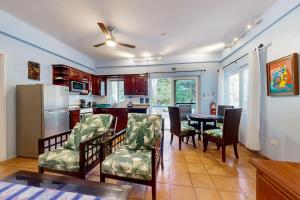 a kitchen and dining room with a table and chairs at Condo #24 @ Beachside Villas in Placencia