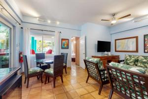 a living room with a table and chairs at Condo #24 @ Beachside Villas in Placencia +20 photos