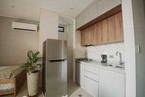 a kitchen with a stainless steel refrigerator and a sink at Magaly House in Sincelejo +9 photos