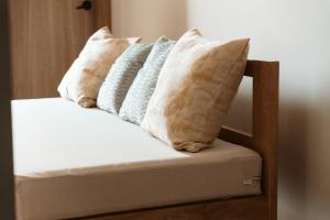 a group of pillows sitting on top of a bed at Magaly House in Sincelejo