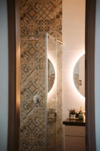 a shower with a glass door in a bathroom at Magaly House in Sincelejo