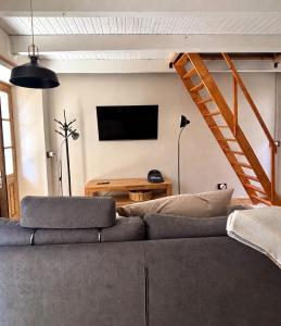 a living room with a couch and a flat screen tv at Casa Giù Là in Quarna Sopra