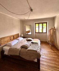 a bedroom with a large bed and a mirror at Casa Giù Là in Quarna Sopra