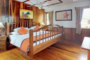 a bedroom with a bed with wooden walls and wood floors at Starfish Cabana at Latitude Adjustment -Gold Standard Certified in Hopkins