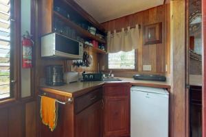 a kitchen with wooden cabinets and a white refrigerator at Starfish Cabana at Latitude Adjustment -Gold Standard Certified in Hopkins +14 photos