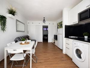 a kitchen and living room with a white table and chairs at Vanessa Puerto del Carmen in Tías