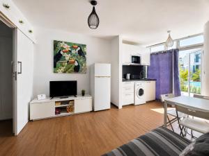 a living room with a kitchen and a dining room at Vanessa Puerto del Carmen in Tías +14 photos