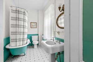 a bathroom with a sink and a toilet and a tub at Inn at the Oaks in Eastham +126 photos