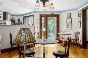 a dining room with two tables and chairs at Inn at the Oaks in Eastham
