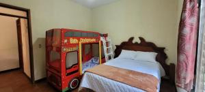 a bedroom with a double decker bus and a bed at casa bugambilia in San Martín Zapotitlán