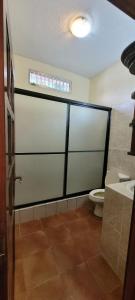 a bathroom with a toilet and a window at casa bugambilia in San Martín Zapotitlán